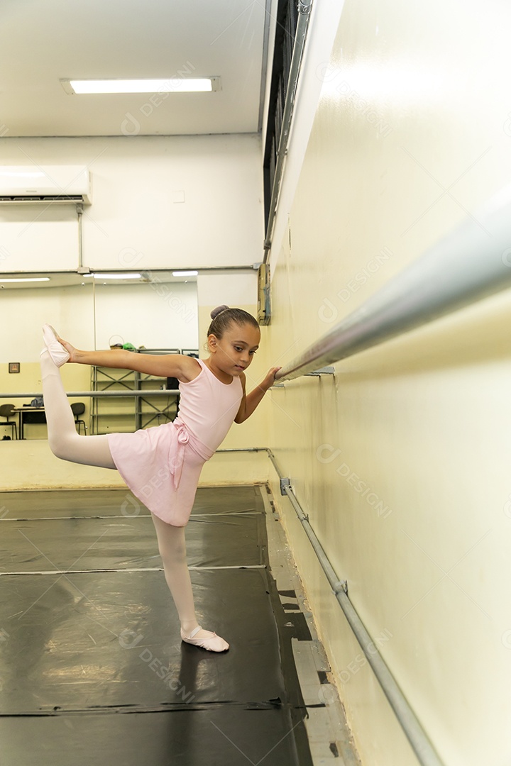 Linda menina sorridente praticando balé sobre escola de dança