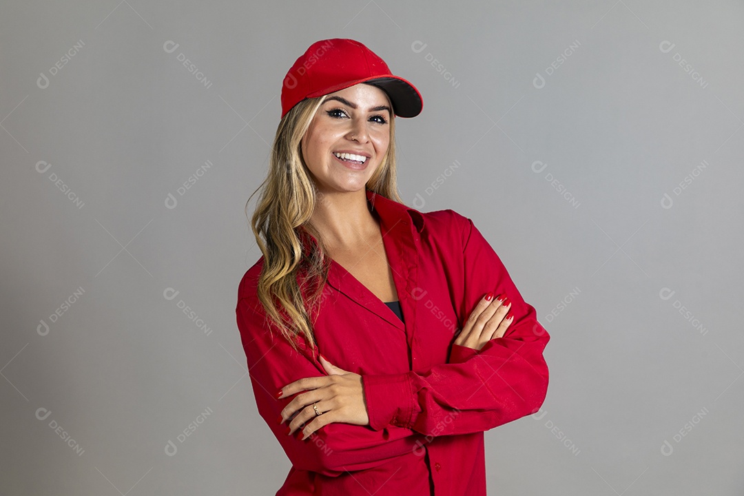 Bela mulher sorridente usando boné vermelho fazendo pose sobre fundo isolado