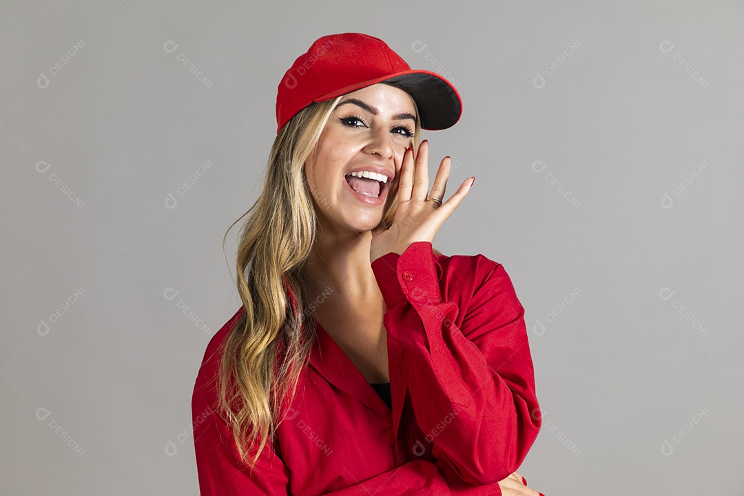 Bela mulher sorridente usando boné vermelho fazendo pose sobre fundo isolado