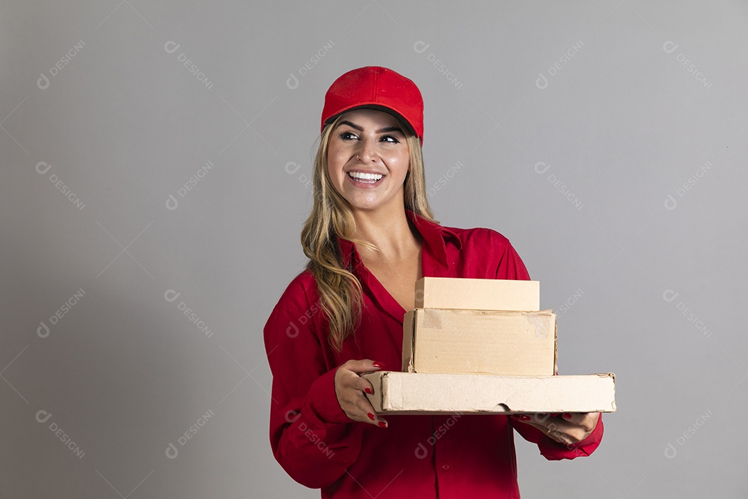 Bela mulher sorridente usando boné segurando pequenas caixas de papelão sobre fundo isolado