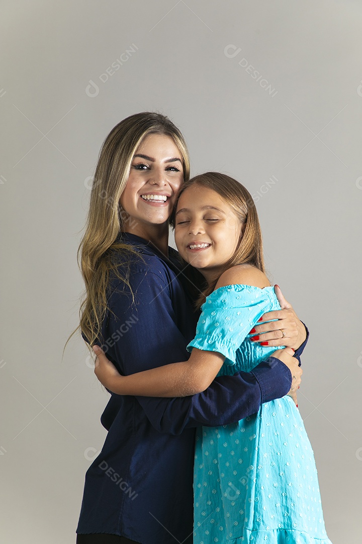 Belo retrato de mãe e filha sorridente se abraçando sobre fundo isolado