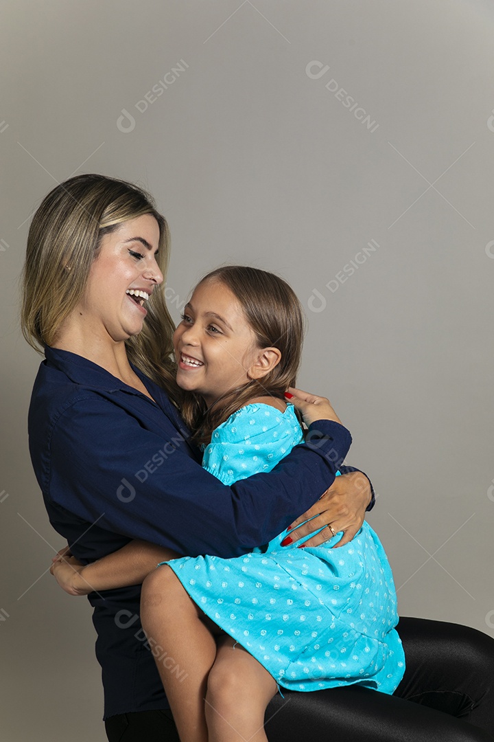 Belo retrato de mãe e filha sorridente sentada ao colo sobre fundo isolado