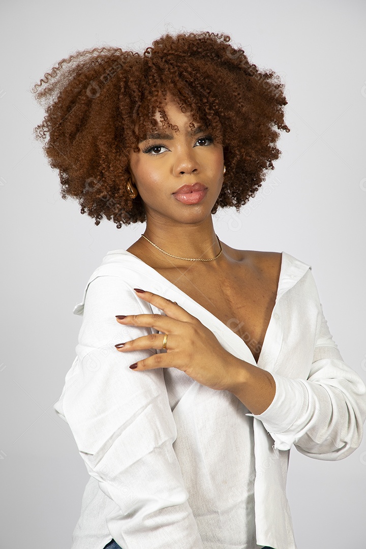 Linda mulher negra de cabelo cacheados fazendo pose sobre fundo branco isolado