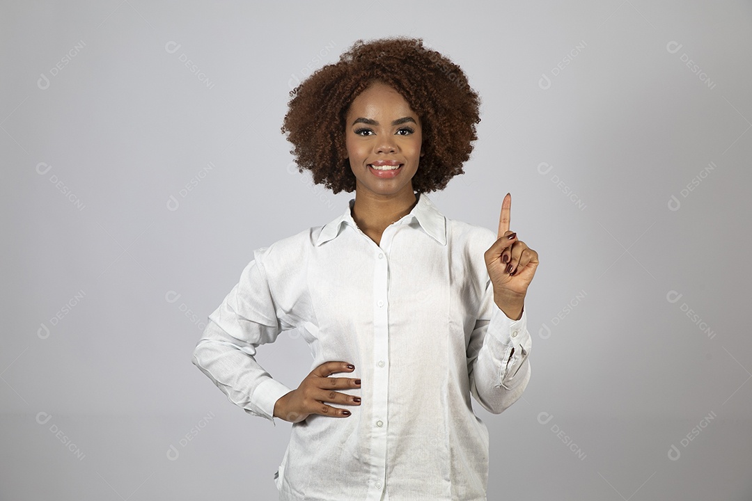 Linda mulher negra de cabelo cacheados fazendo pose sobre fundo branco isolado