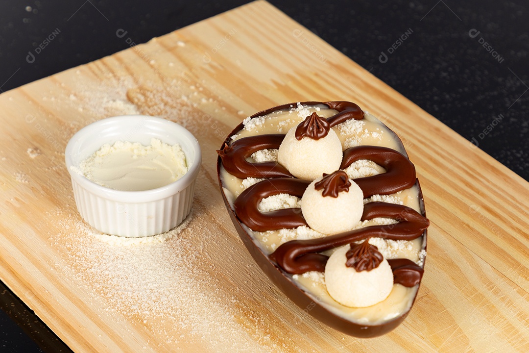 Delicioso ovo de páscoa sobre uma tábua de madeira