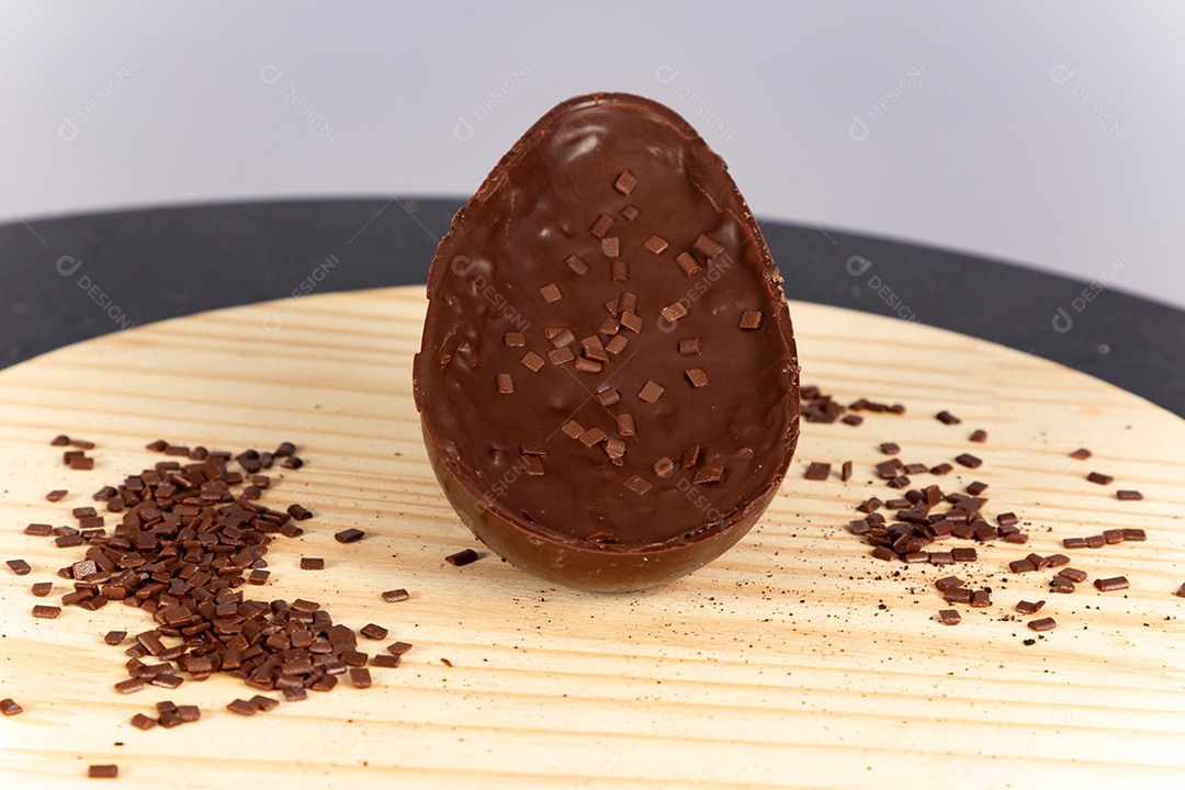 Delicioso ovo de páscoa sobre uma tábua de madeira