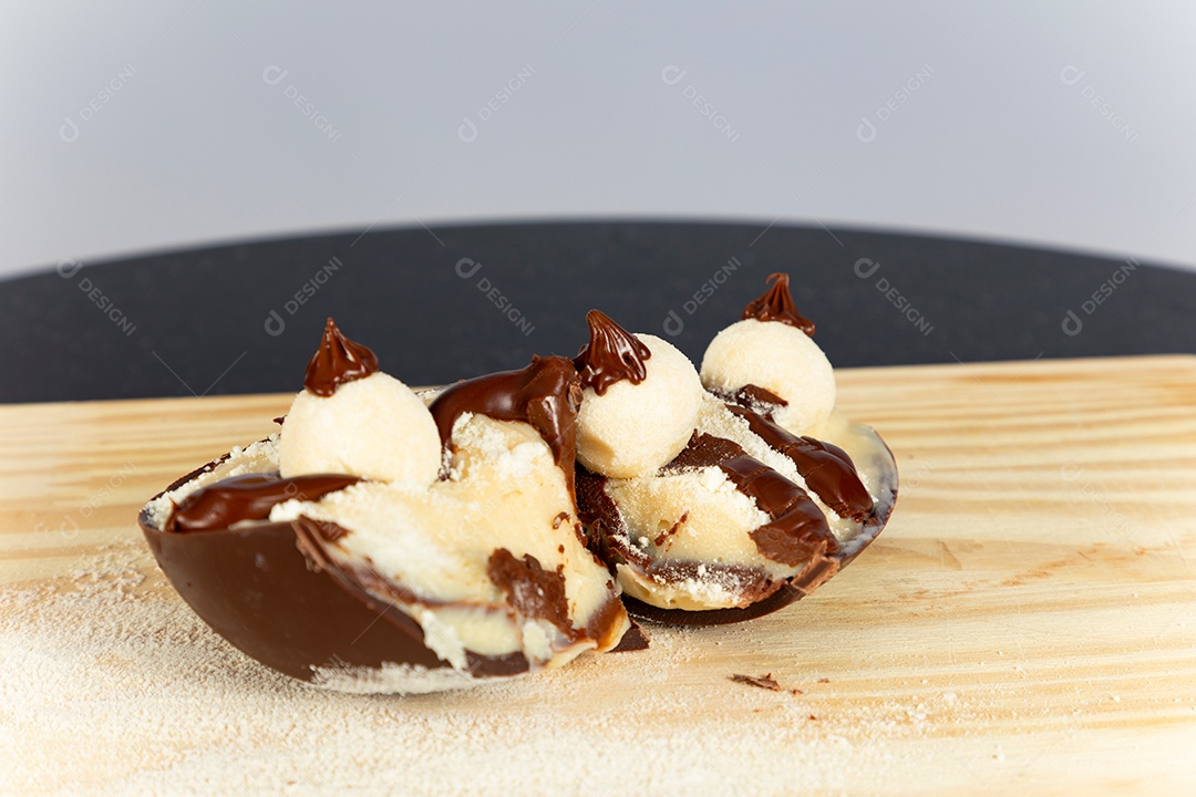 Delicioso ovo de páscoa sobre uma tábua de madeira