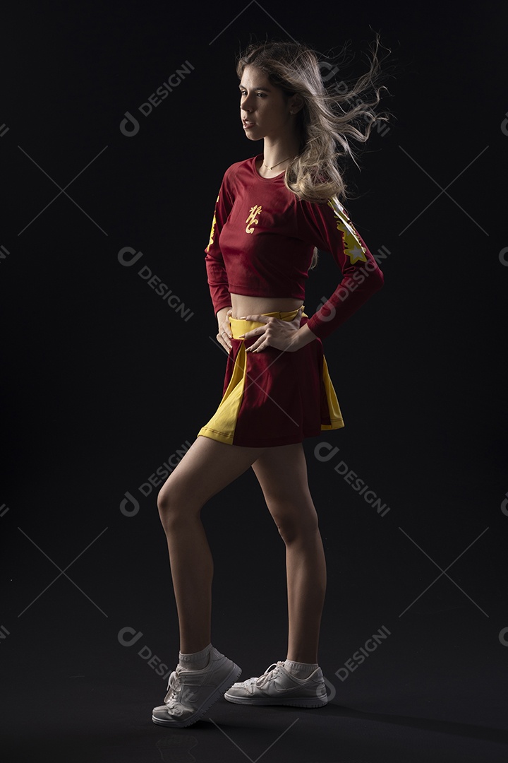 Jovem loira usando um vestido luxuoso em um fundo preto