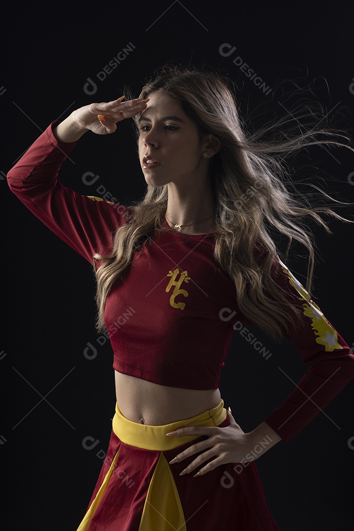 Jovem loira usando um vestido luxuoso em um fundo preto