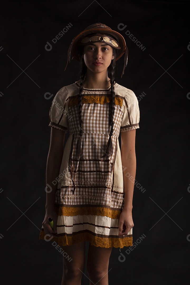 Jovem mulher em traje típico de festa junina com vestido e chapéu de couro