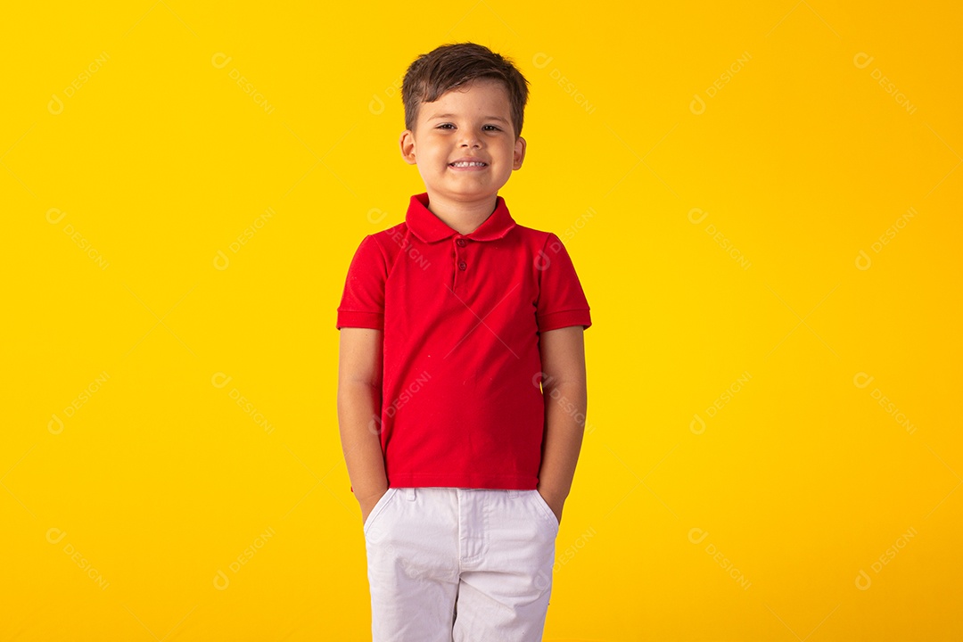 Criança do sexo masculino em foto de estúdio com fundo claro vestindo camisa e jeans