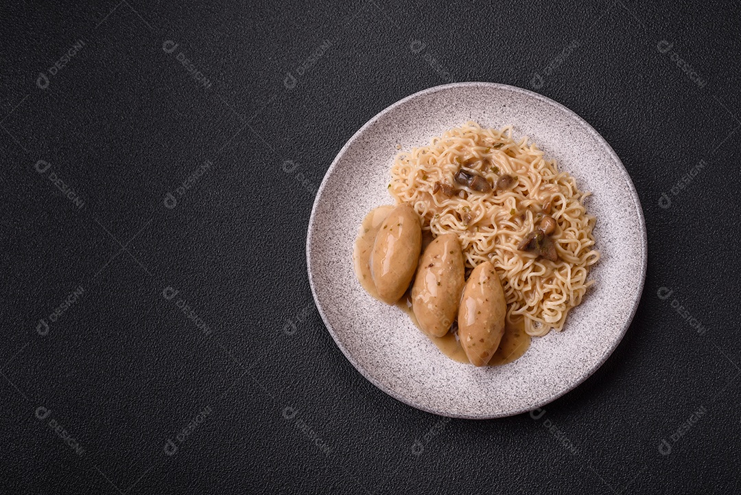 Prato de macarrão com carne em uma mesa de concreto