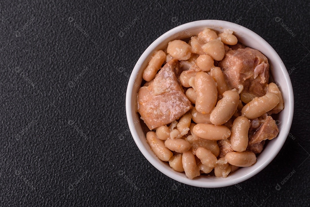 Feijões crus, secos, vermelhos e brancos, sobre um fundo de concreto escuro. Cozinhando Alimentos Saudáveis