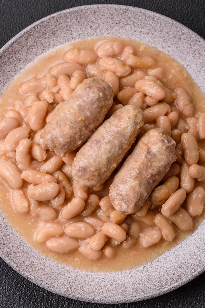 Feijões crus, secos, vermelhos e brancos, sobre um fundo de concreto escuro. Cozinhando Alimentos Saudáveis