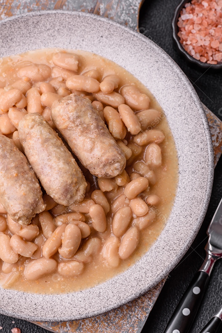 Feijões crus, secos, vermelhos e brancos, sobre um fundo de concreto escuro. Cozinhando Alimentos Saudáveis