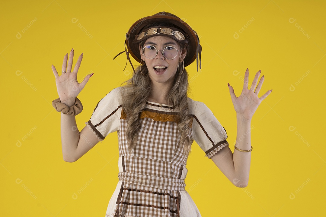 Mulher jovem usando roupas tipicas de festa junina e usando um chapeu de couro e óculos