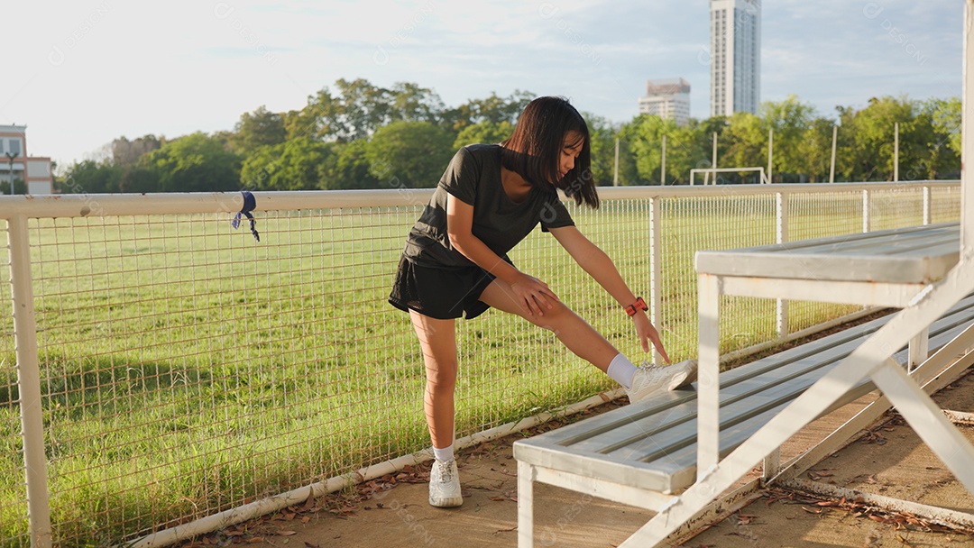 Adolescente asiática se alongando ao ar livre