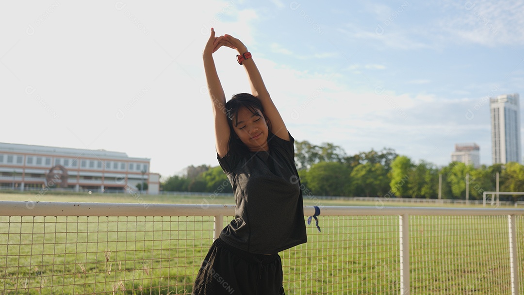 Adolescente asiática se alongando ao ar livre