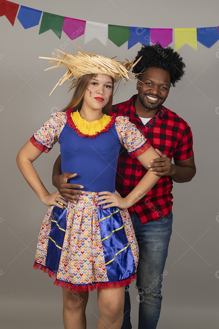 Lindo casal de jovens celebrando festa junina usando roupas típicas