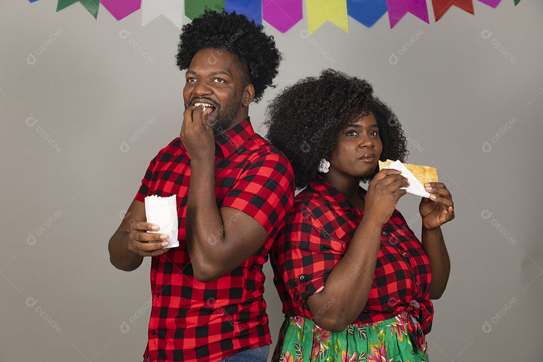 Lindo casal de jovens ao lado de sua filha celebrando festa junina usando roupas típicas