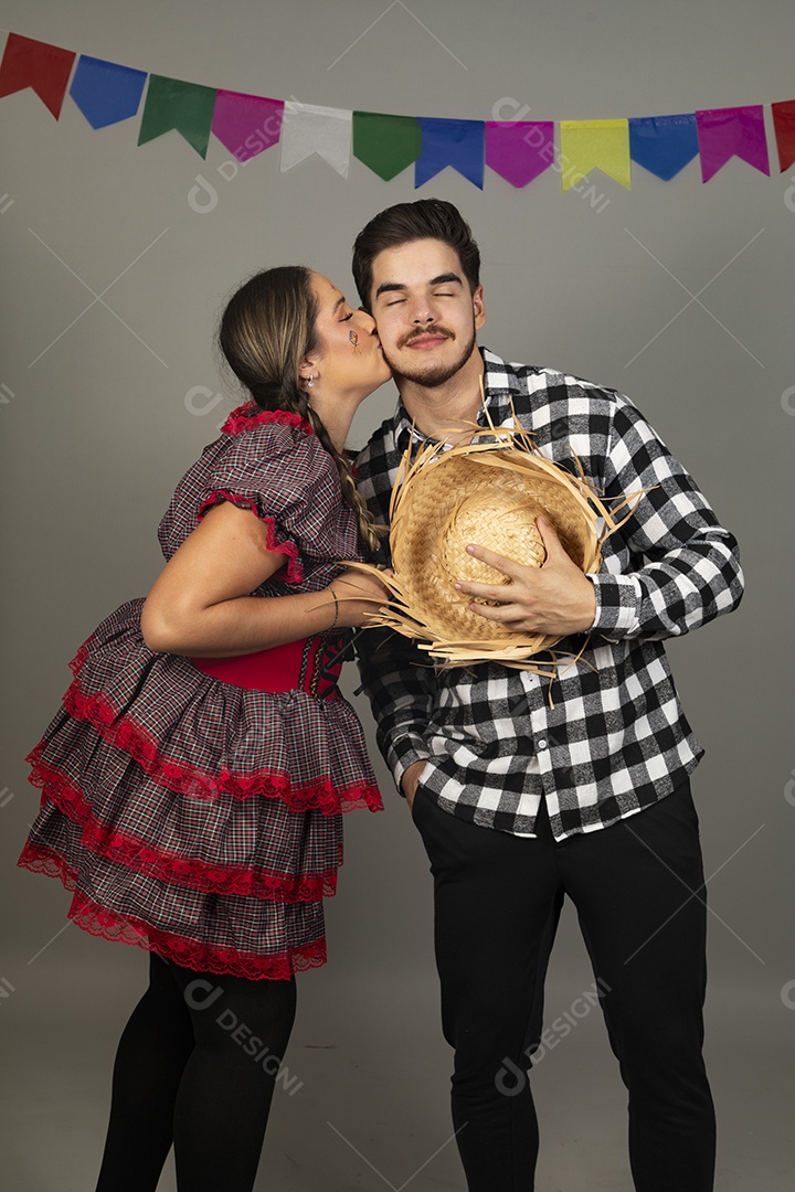 Homem jovem celebrando festa junina ao lado de sua mãe