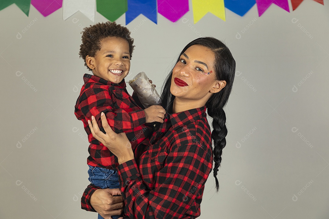 Mãe jovem usando roupas típicas festa junina sobre fundo isolado ao lado de seu filho