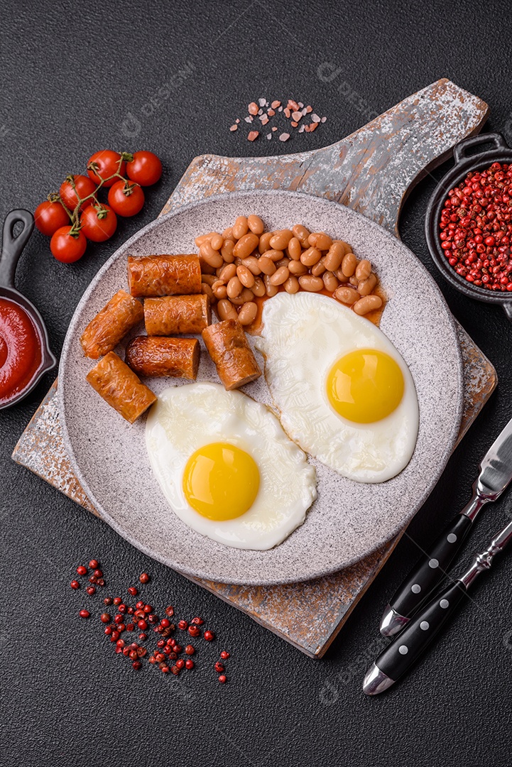Prato de comida linguiça e ovo frito feijão mesa concreto