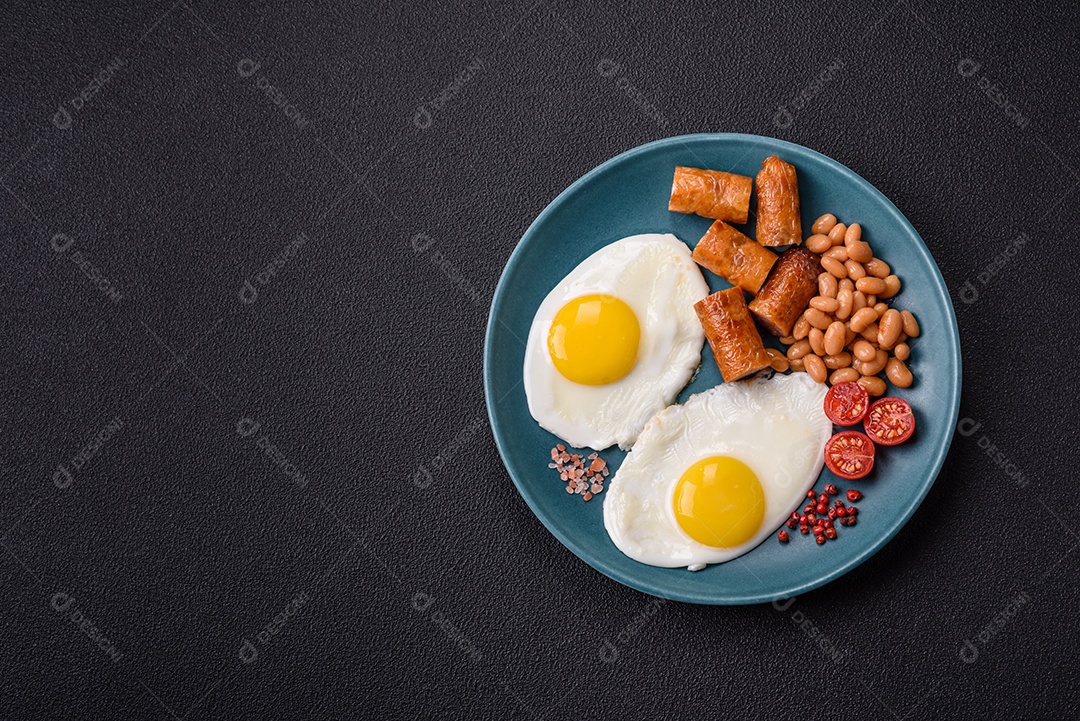 Prato de comida linguiça e ovo frito feijão mesa concreto