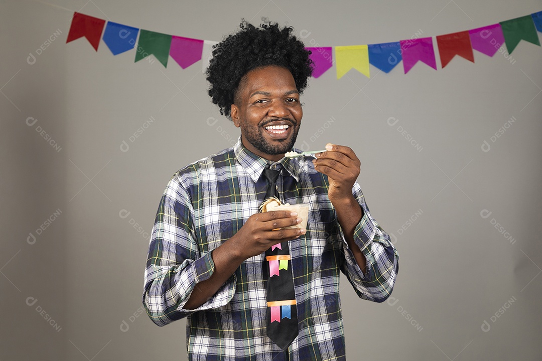 Homem jovem usando roupas típicas de festa junina sobre fundo isolado