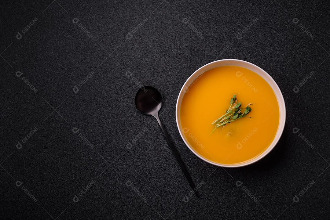 Sopa de abóbora e cenoura em uma mesa de concreto