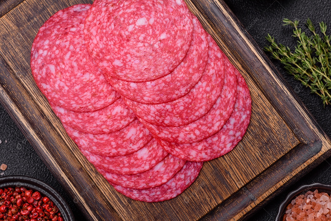 Delicioso salame fatiado em uma mesa de concreto