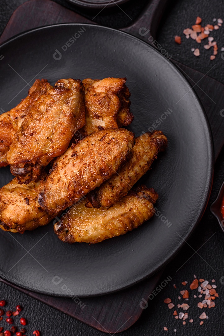 Asas de frango assadas saborosas em uma mesa de concreto