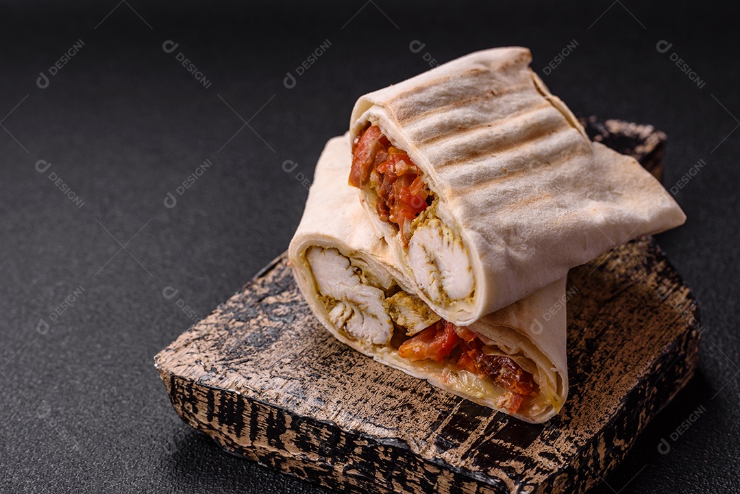 Imagem mostra dois wraps ou shawarmas cortados ao meio e servidos em um prato