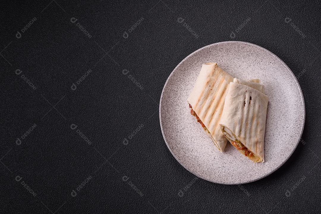 Imagem mostra dois wraps ou shawarmas cortados ao meio e servidos em um prato