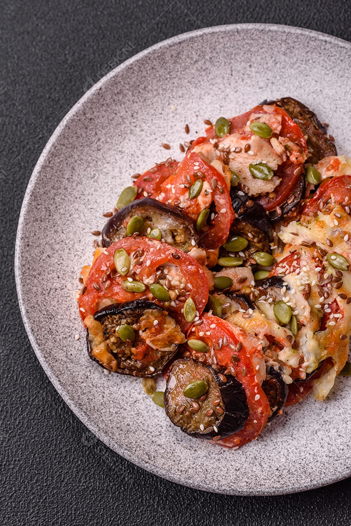 Imagem mostra berinjelas preparadas, tomates frescos e um molho à base de tomate