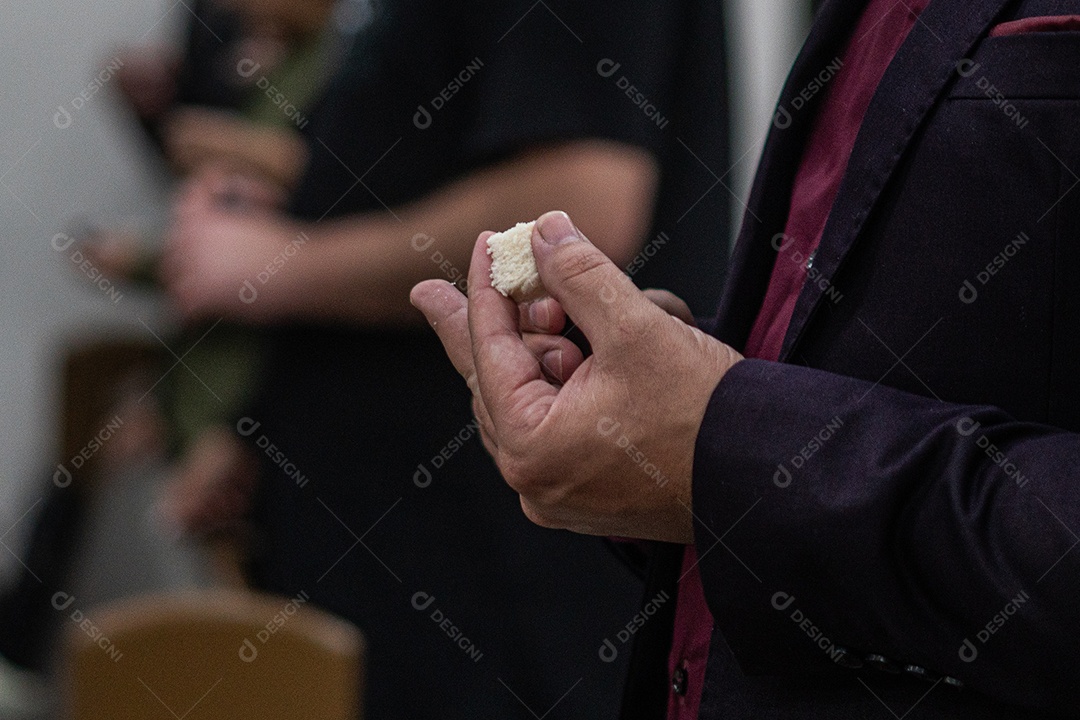 Mão de uma mulher segurando santa ceia sob uma igreja