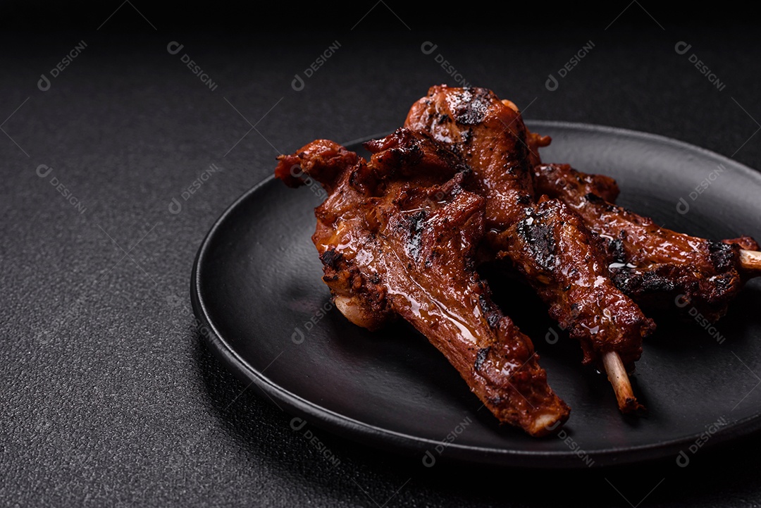 Costelas de porco grelhadas ou assadas, provavelmente com molho barbecue