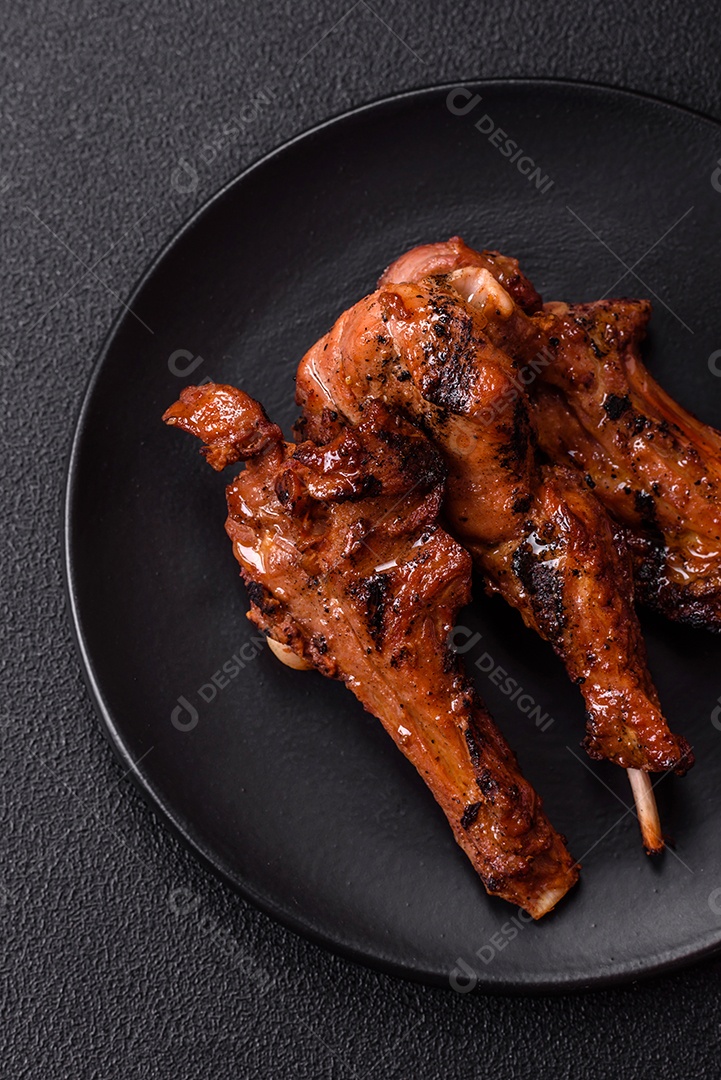 Costelas de porco grelhadas ou assadas, provavelmente com molho barbecue