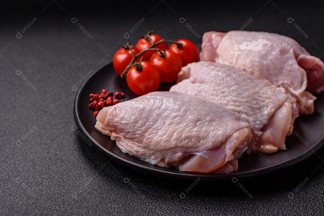 Sobrecoxas de frango cruas, prontas para serem preparadas. A sobrecoxa