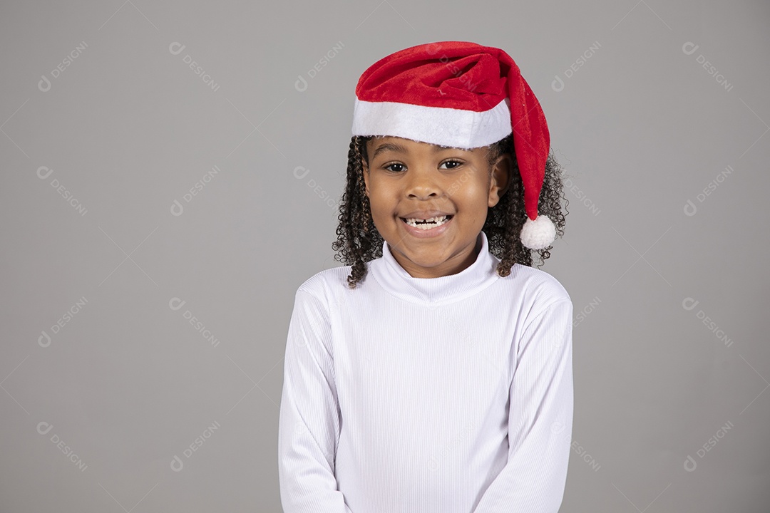 Linda garotinha sorridente usando roupa do papai Noel celebrando natal