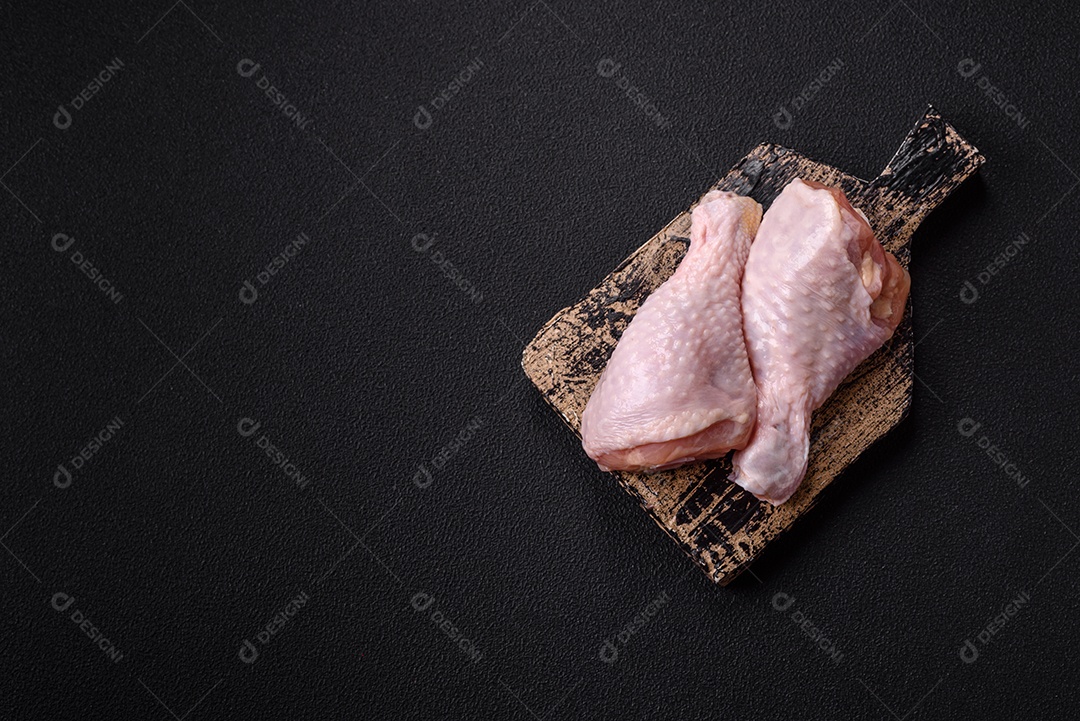 A imagem mostra sobrecoxas de frango cruas, com pele e osso, prontas para serem preparadas