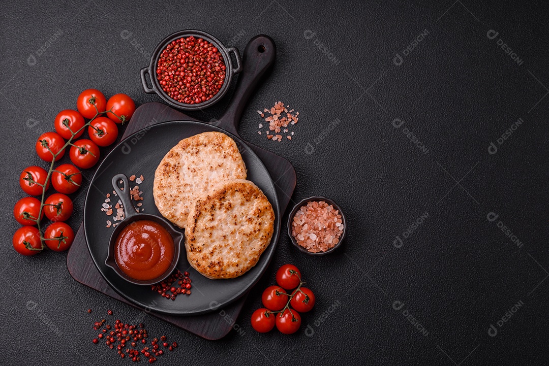 A imagem mostra chuletas de porco grelhadas, acompanhadas de ramos de tomilho e tomates cereja.