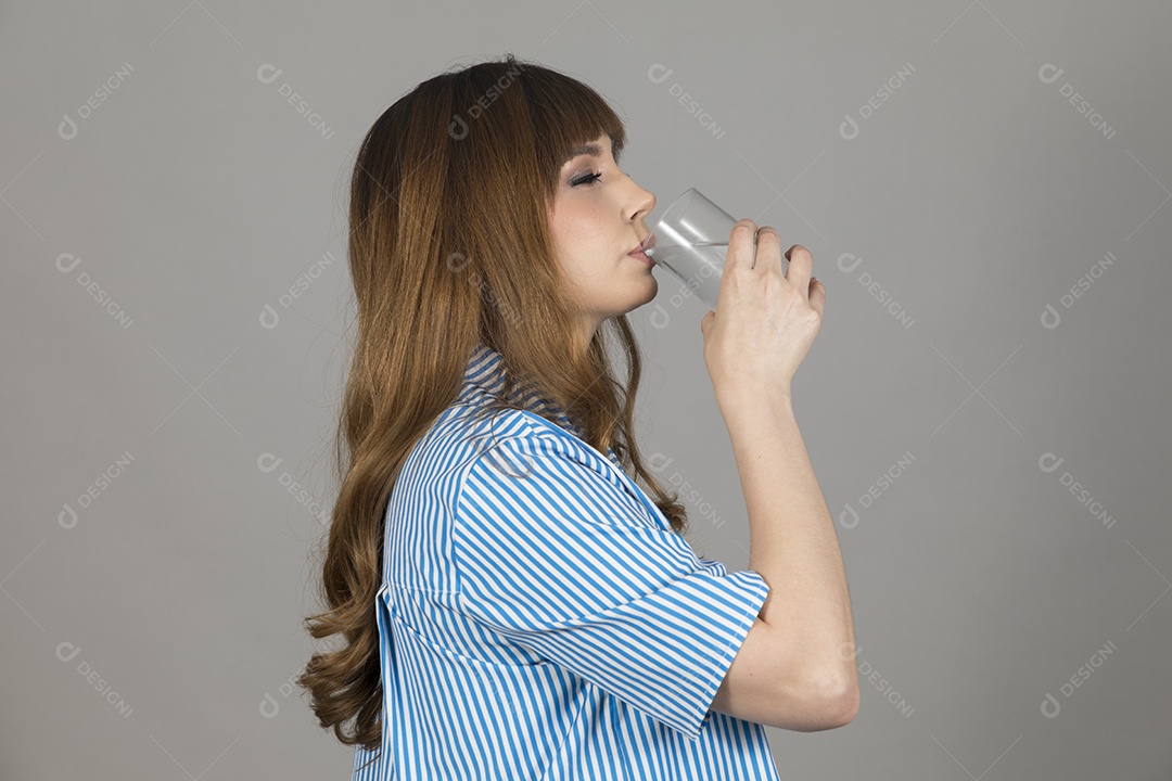 Linda mulher jovem sobre fundo isolado segurando copo de vidro com água