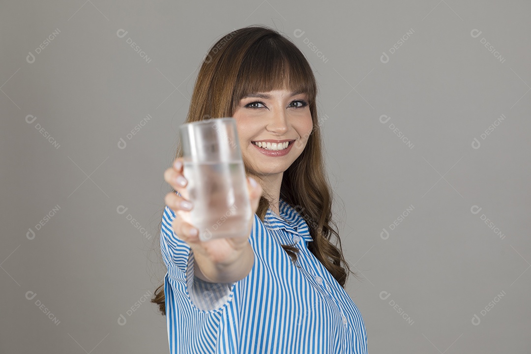 Linda mulher jovem sobre fundo isolado segurando copo de vidro com água