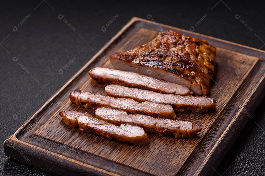A imagem mostra fatias de carne de porco grelhada, provavelmente lombo ou um corte similar, servidas em uma tábua de madeira.