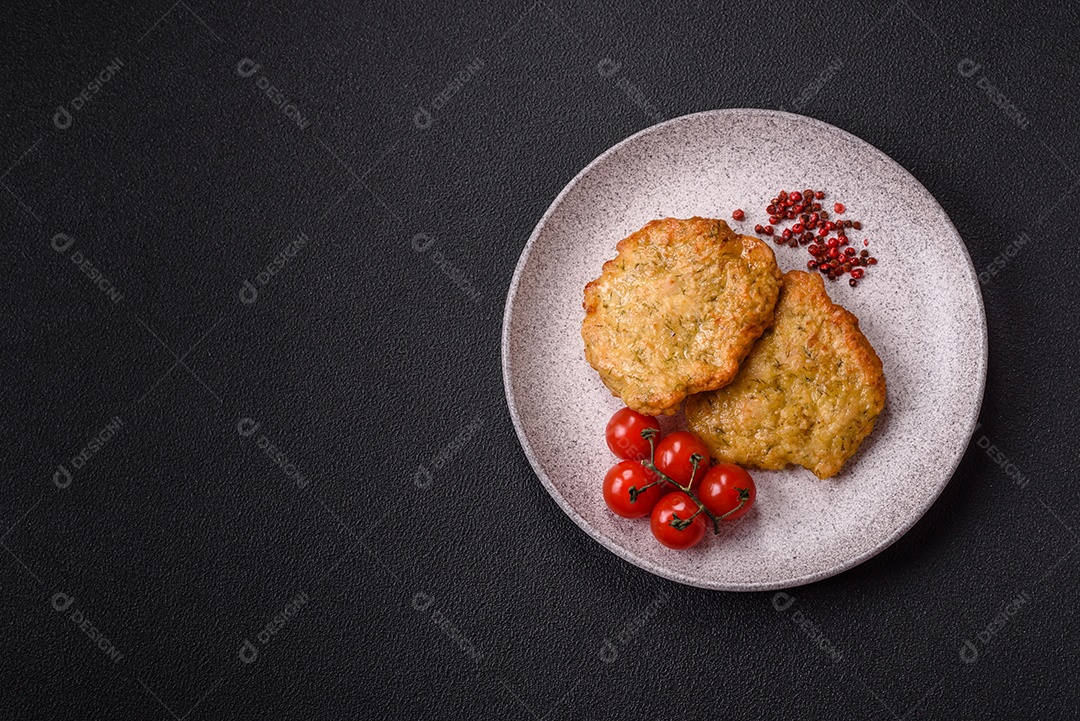 A imagem mostra pedaços de frango frito, acompanhados por tomates cereja e pimenta rosa.