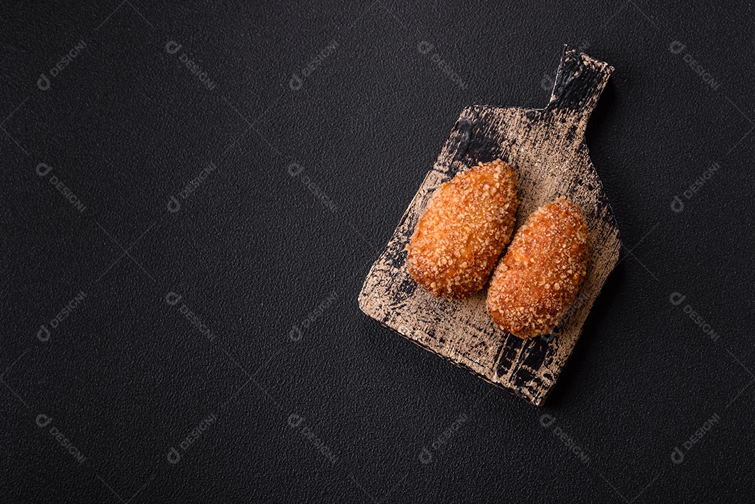 A imagem mostra Frango à Kiev, um prato de frango empanado e frito, recheado com manteiga de ervas.