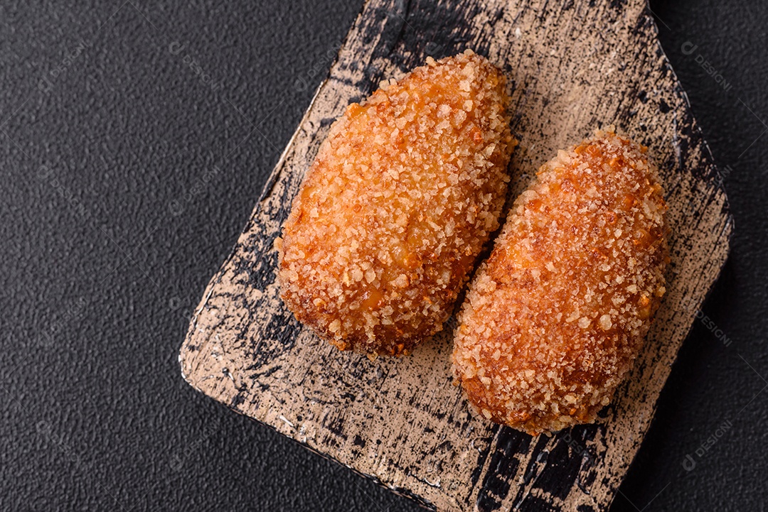 A imagem mostra Frango à Kiev, um prato de frango empanado e frito, recheado com manteiga de ervas.