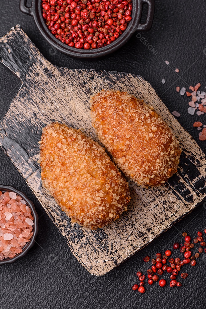 A imagem mostra Frango à Kiev, um prato de frango empanado e frito, recheado com manteiga de ervas.