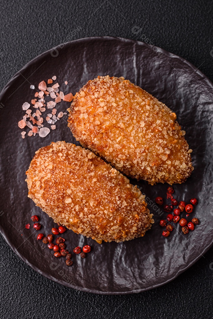 A imagem mostra Frango à Kiev, um prato de frango empanado e frito, recheado com manteiga de ervas.